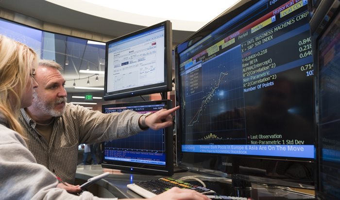 Professor and student working in the Bloomberg terminal